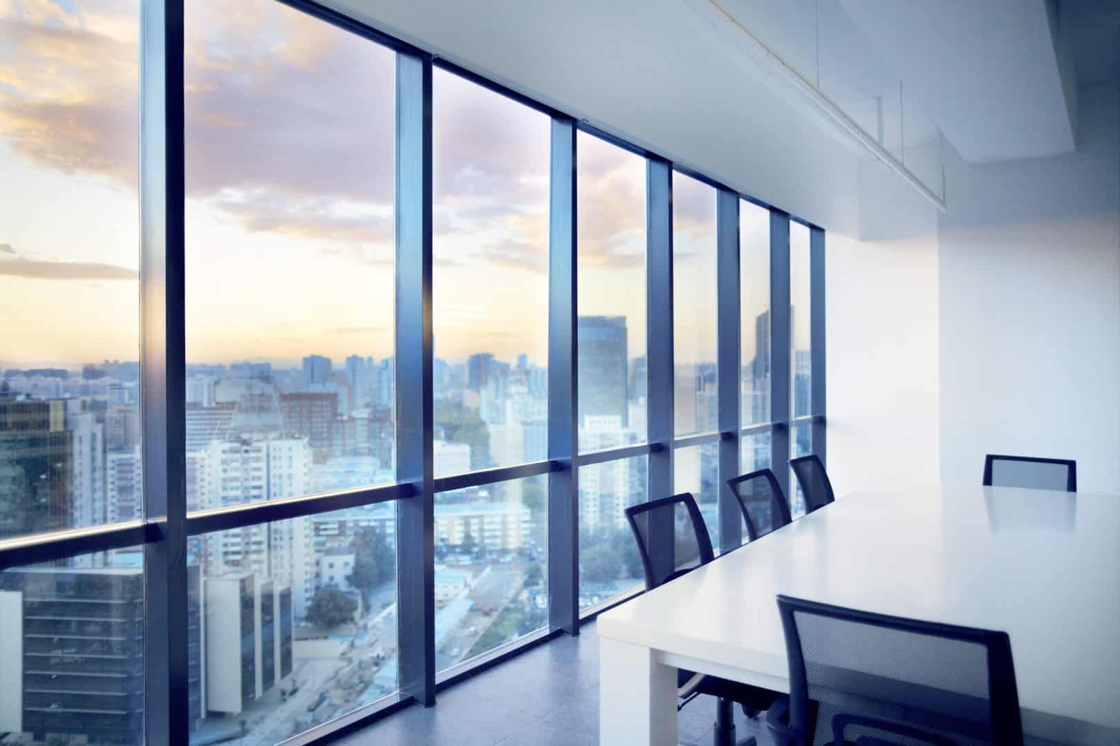 Meeting room with window view of cityscape clouds